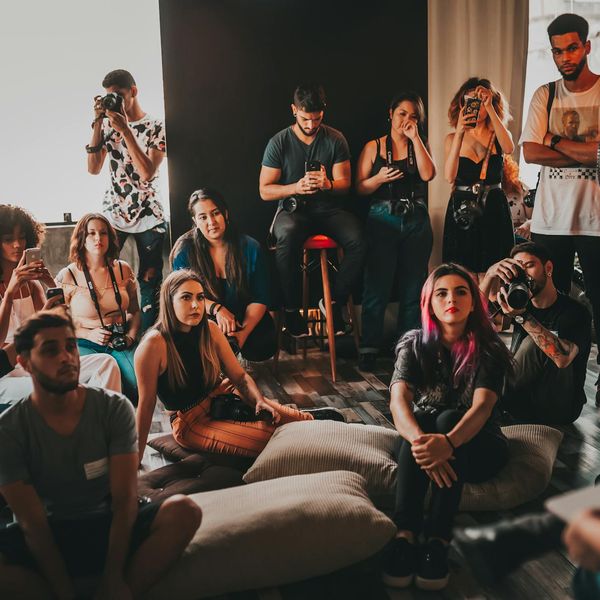 Group of diverse people practicing yoga together in a bright studio.